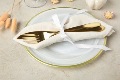 Stylish place setting with autumnal decor on grey textured table