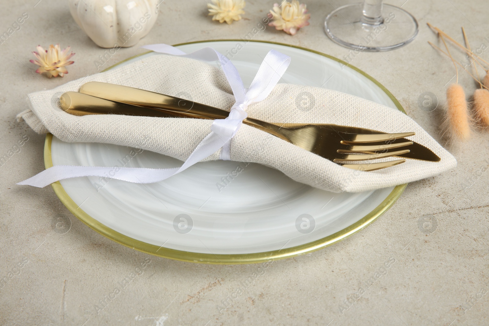 Photo of Stylish place setting with autumnal decor on grey textured table