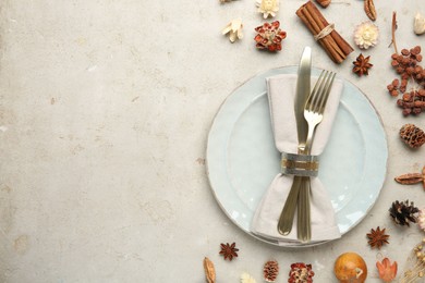 Stylish place setting and autumn decor on grey textured table. Space for text