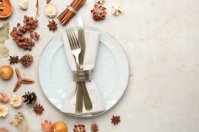 Stylish place setting and autumn decor on grey textured table. Space for text