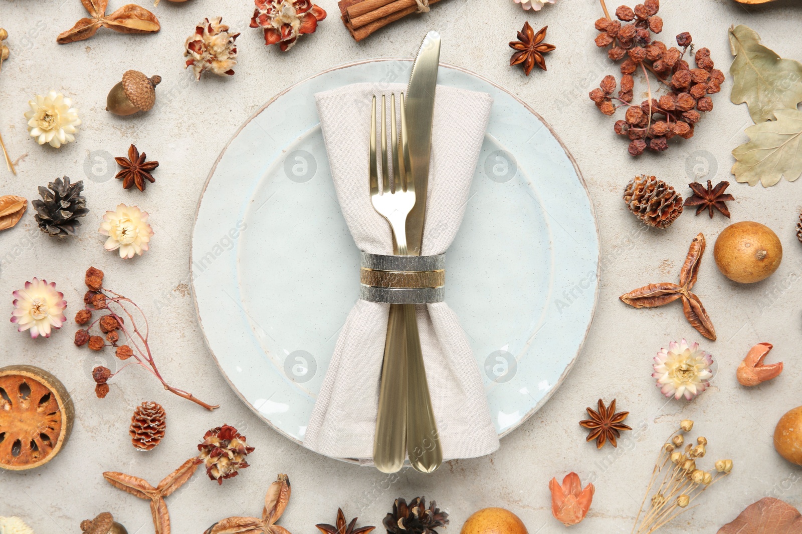 Photo of Stylish place setting and autumn decor on grey textured table