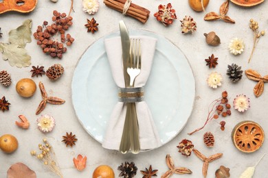 Stylish place setting and autumn decor on grey textured table