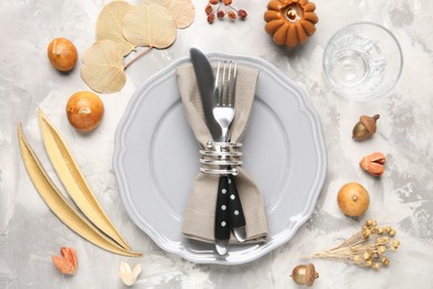 Photo of Stylish place setting with autumnal decor on grey textured table