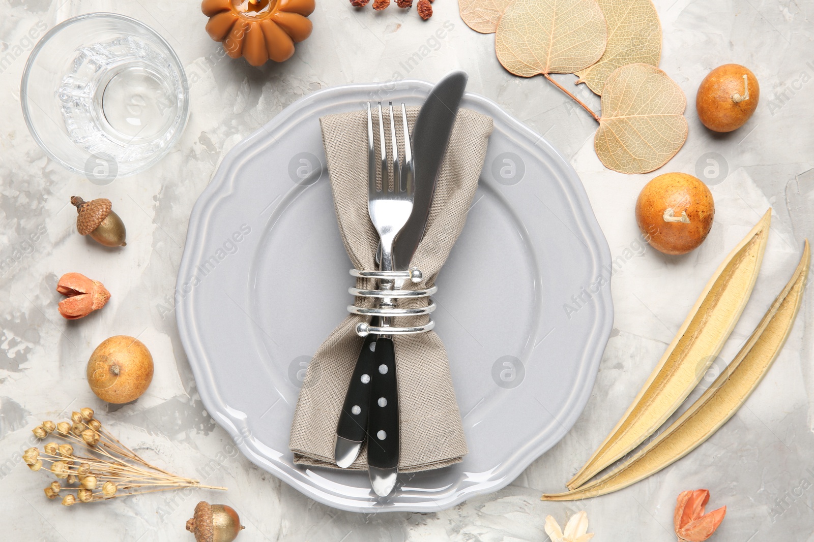 Photo of Stylish place setting with autumnal decor on grey textured table