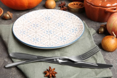 Photo of Stylish place setting and autumn decor on grey textured table