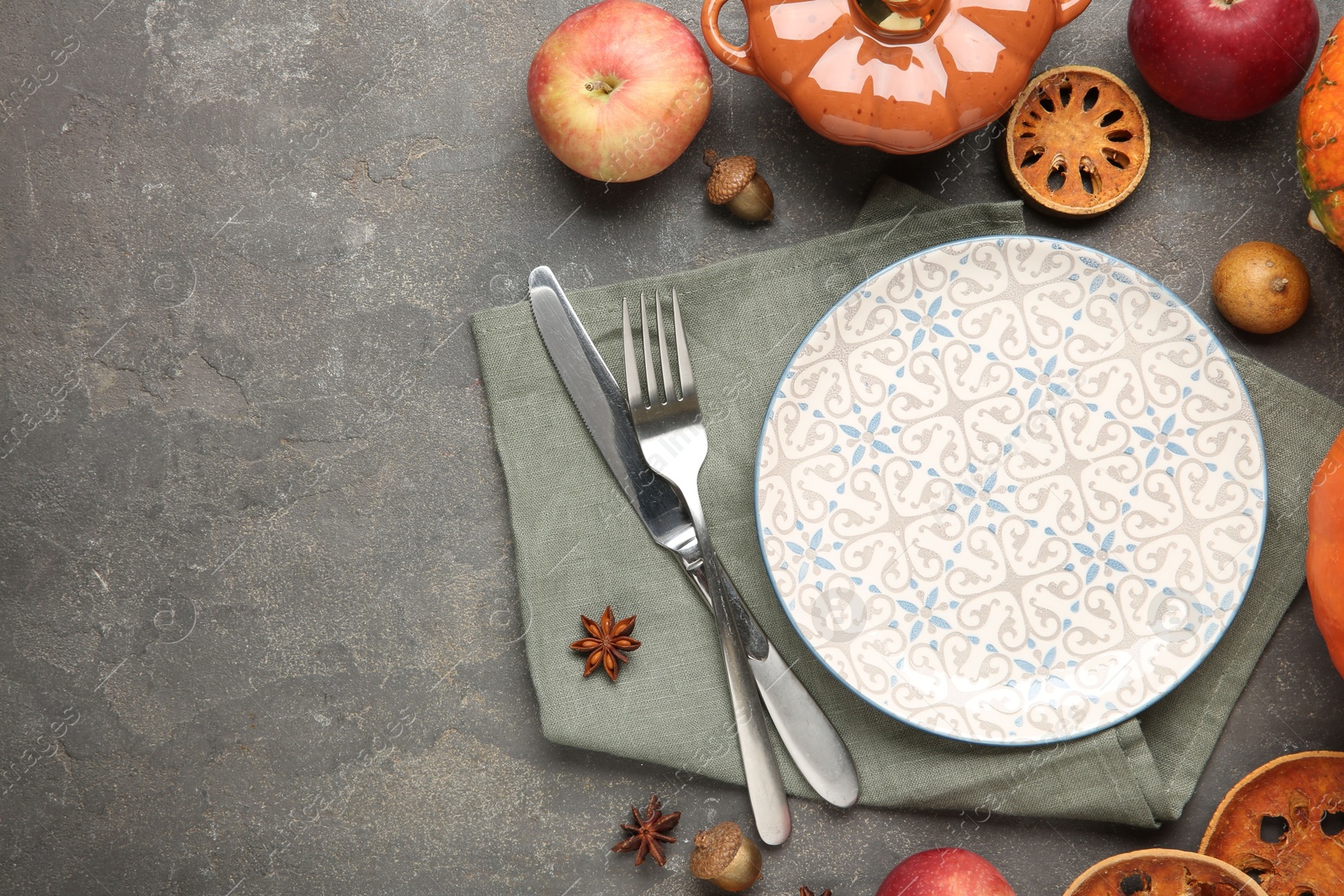 Photo of Stylish place setting and autumn decor on grey textured table. Space for text