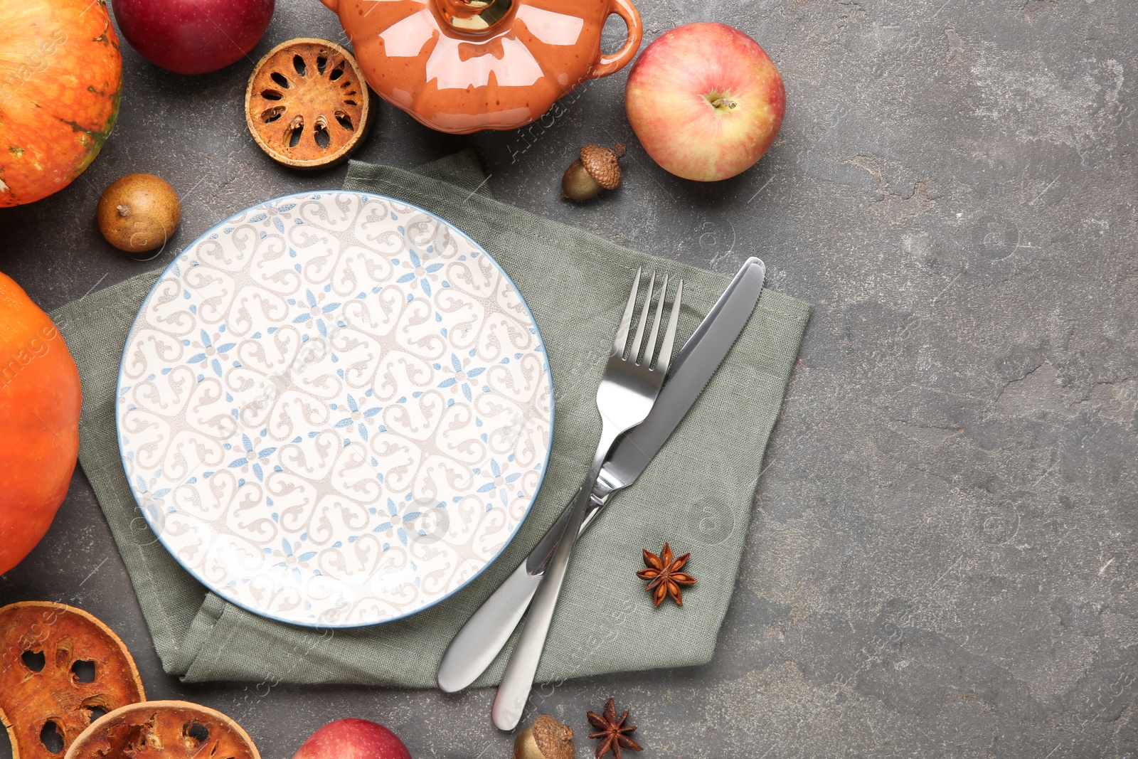 Photo of Stylish place setting and autumn decor on grey textured table. Space for text