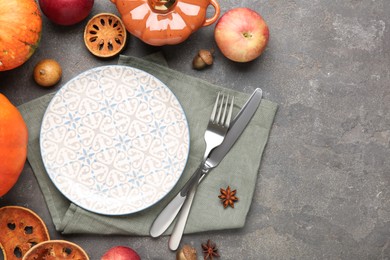 Photo of Stylish place setting and autumn decor on grey textured table. Space for text