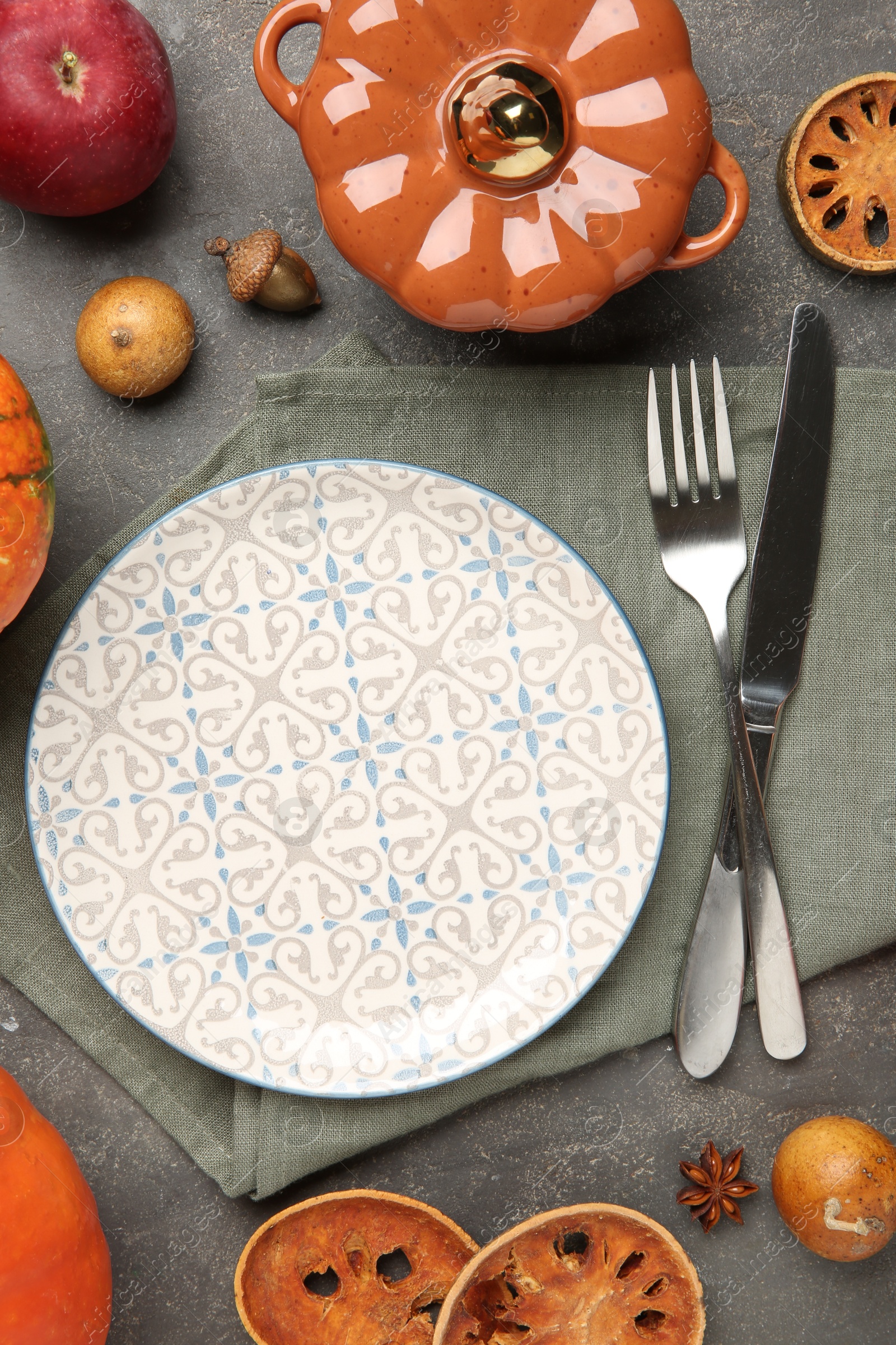 Photo of Stylish place setting and autumn decor on grey textured table