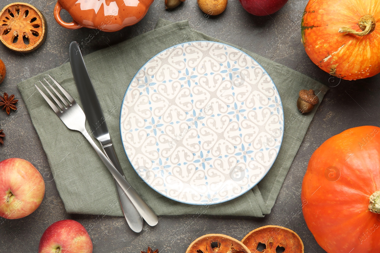 Photo of Stylish place setting and autumn decor on grey textured table