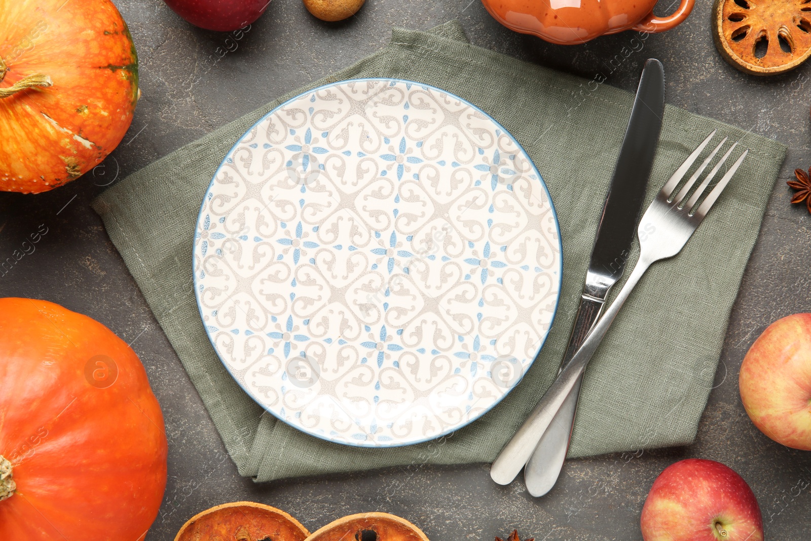 Photo of Stylish place setting and autumn decor on grey textured table