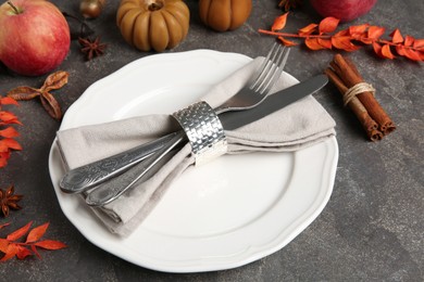 Stylish place setting and autumn decor on grey textured table