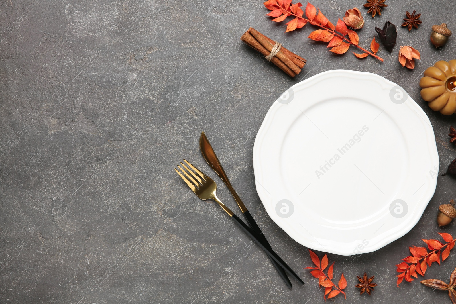 Photo of Stylish place setting and autumn decor on grey textured table. Space for text