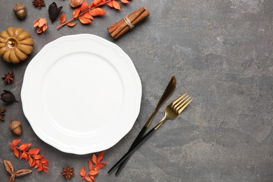 Photo of Stylish place setting and autumn decor on grey textured table. Space for text