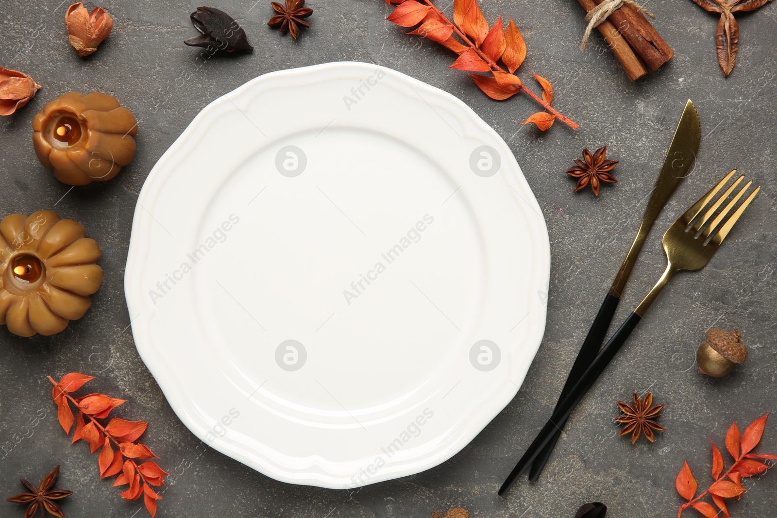 Photo of Stylish place setting and autumn decor on grey textured table