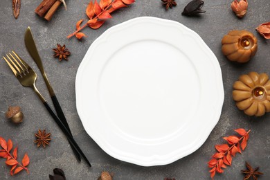 Photo of Stylish place setting and autumn decor on grey textured table