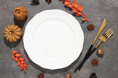 Stylish place setting and autumn decor on grey textured table