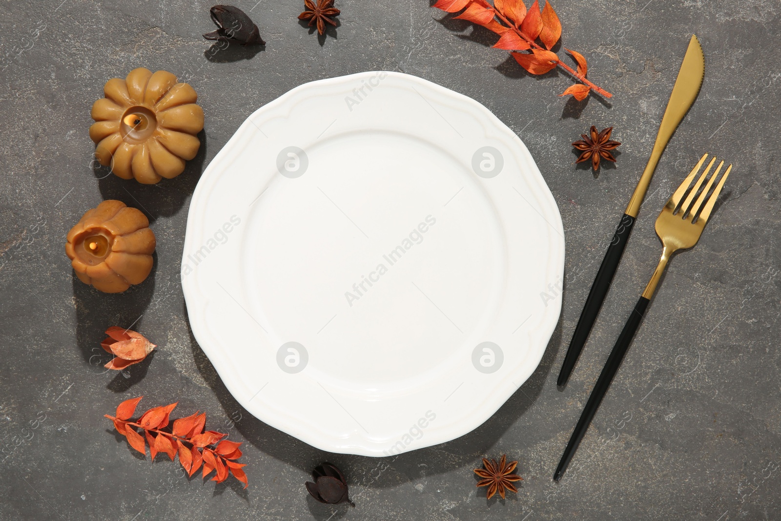 Photo of Stylish place setting and autumn decor on grey textured table