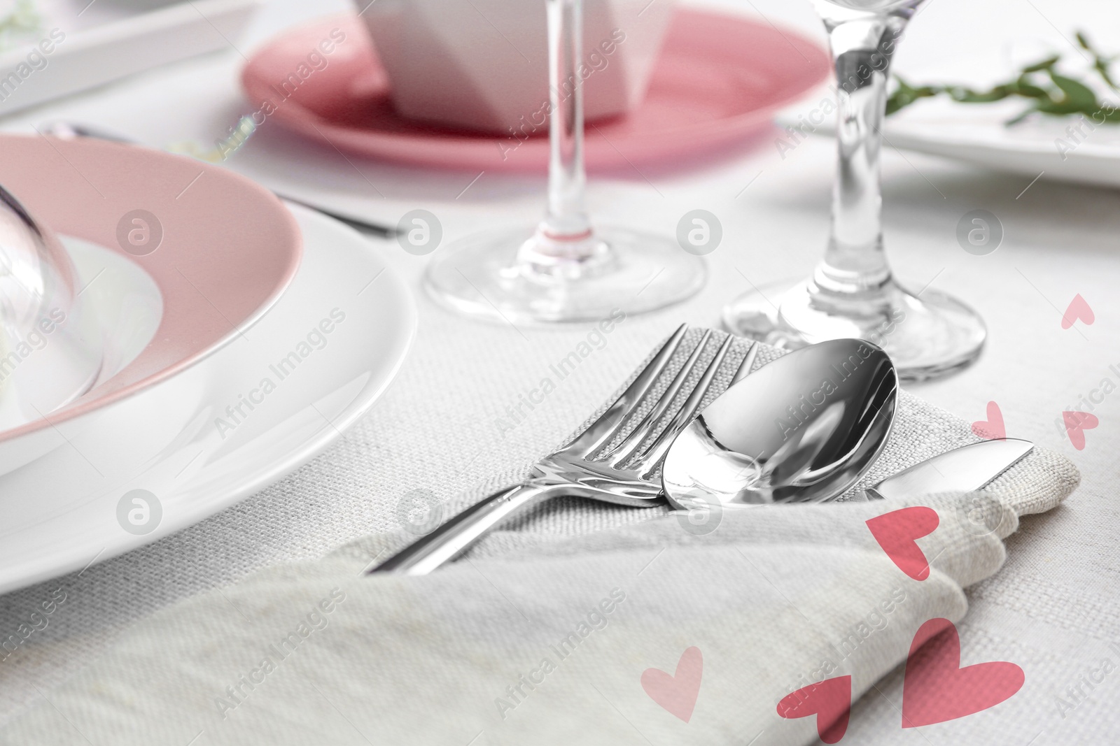 Image of Table setting for romantic Valentine's day celebration. Plates, cutlery and hearts