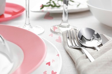 Image of Table setting for romantic Valentine's day celebration. Plates, cutlery and hearts