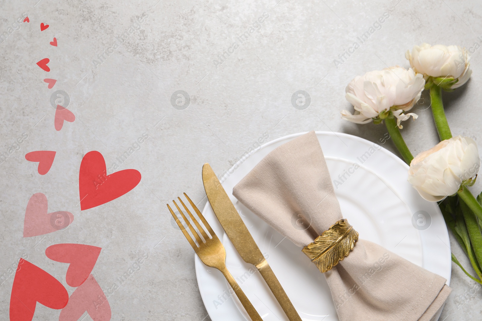 Image of Table setting for romantic Valentine's day celebration, top view. Plates, cutlery, flowers and hearts on grey table