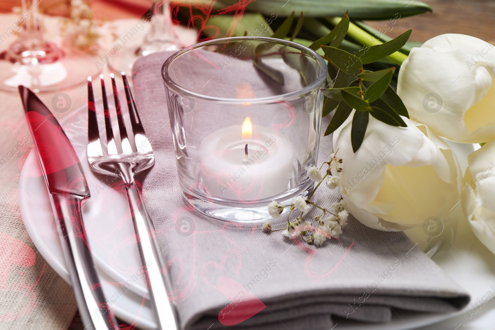 Image of Table setting for romantic Valentine's day celebration. Plates, cutlery, flowers and candle on table, closeup