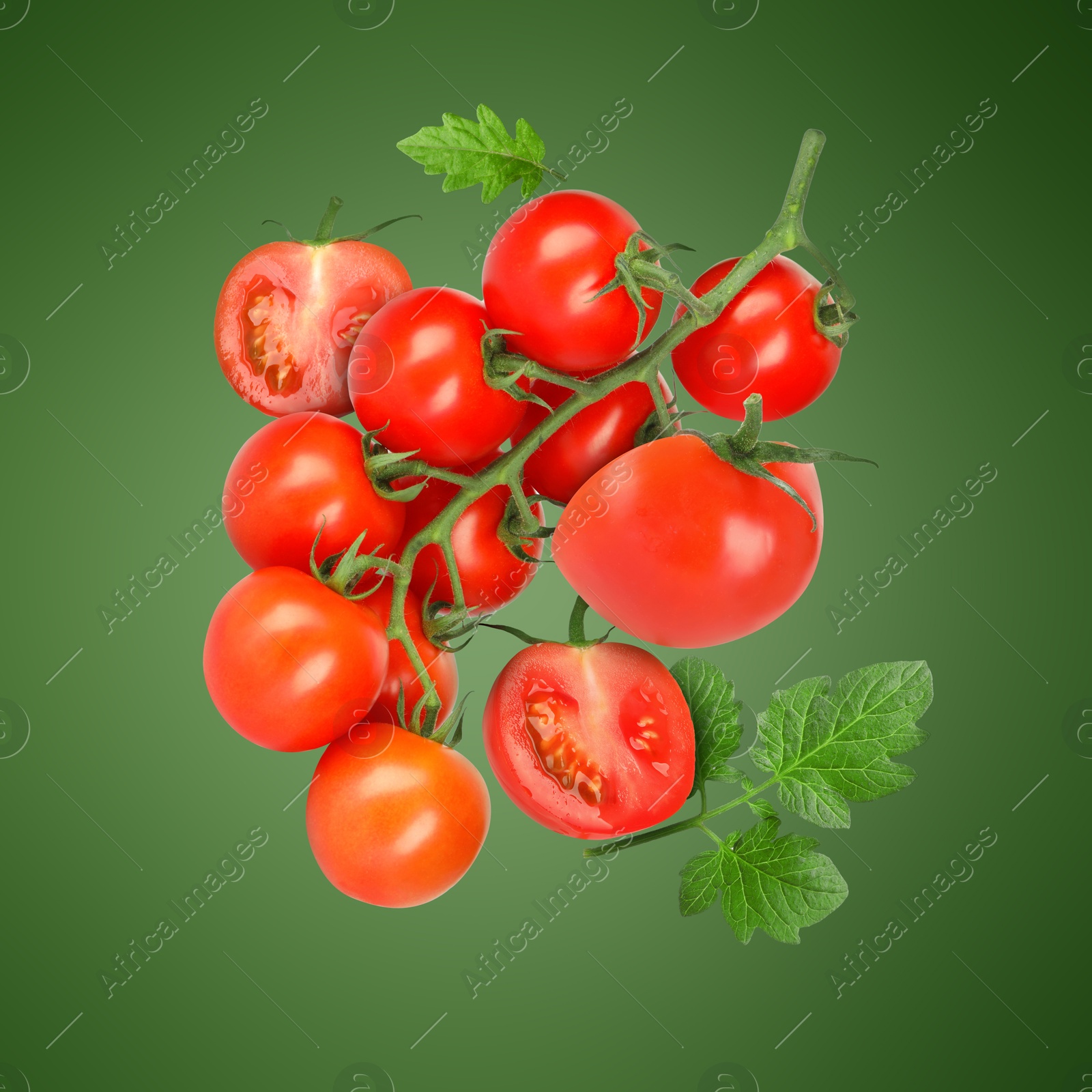 Image of Fresh tomatoes with leaves in air on green background