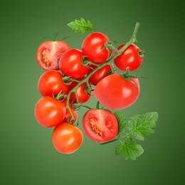 Image of Fresh tomatoes with leaves in air on green background