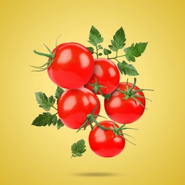 Image of Fresh tomatoes with green leaves falling on golden background