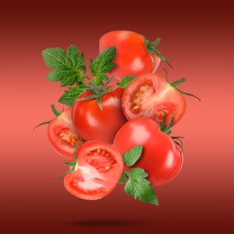 Image of Fresh tomatoes with green leaves falling on red gradient background