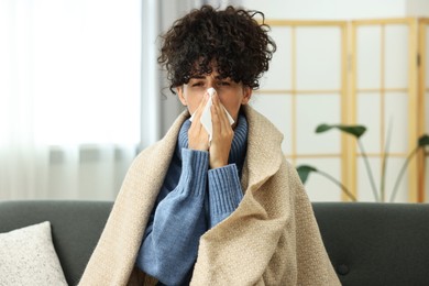 Cold symptom. Young woman with tissue at home