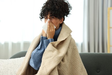 Cold symptom. Young woman with tissue at home