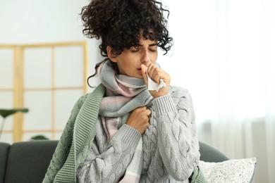 Cold symptom. Young woman with tissue at home