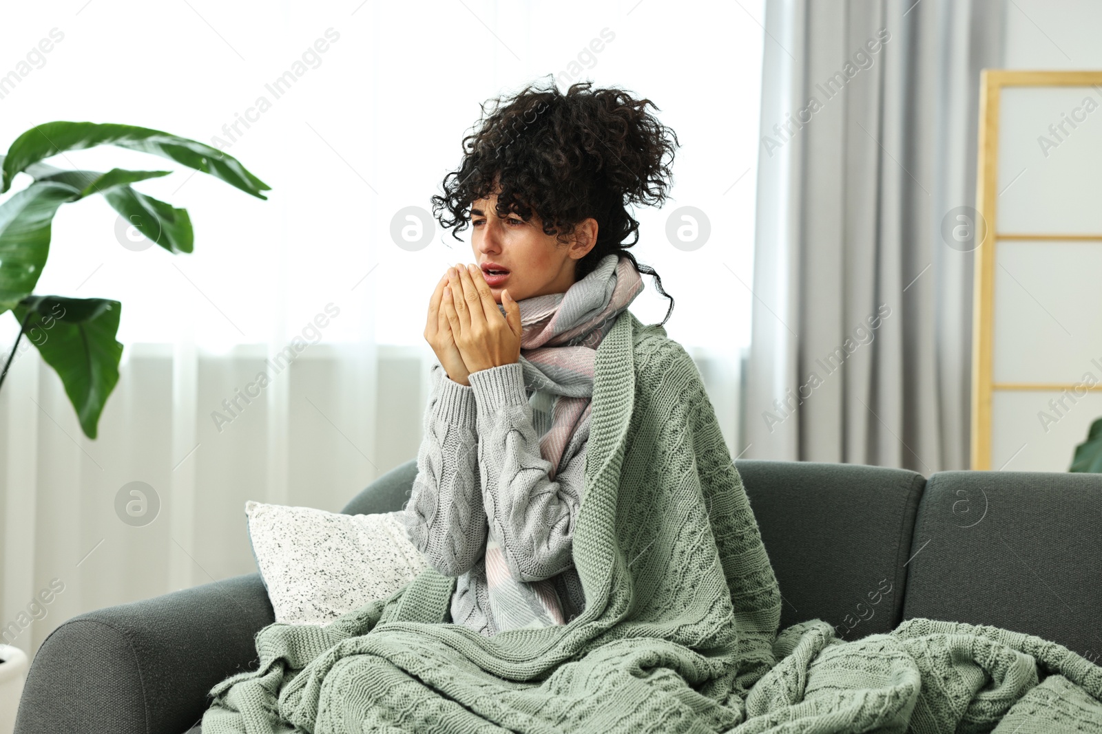 Photo of Cold symptom. Young woman suffering from illness at home