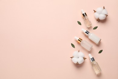 Photo of Different cosmetic products, leaves and cotton flowers on beige background, flat lay. Space for text