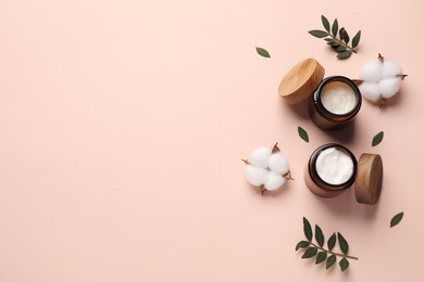 Photo of Different cosmetic products, leaves and cotton flowers on beige background, flat lay. Space for text