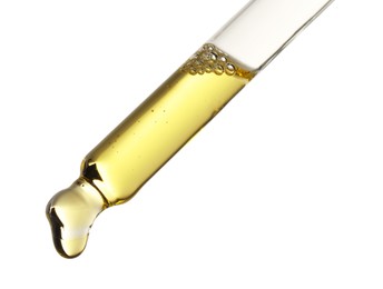 Photo of Essential oil dripping from pipette against white background