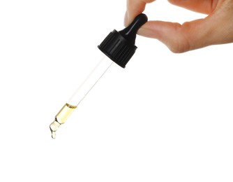 Photo of Essential oil dripping from pipette against white background