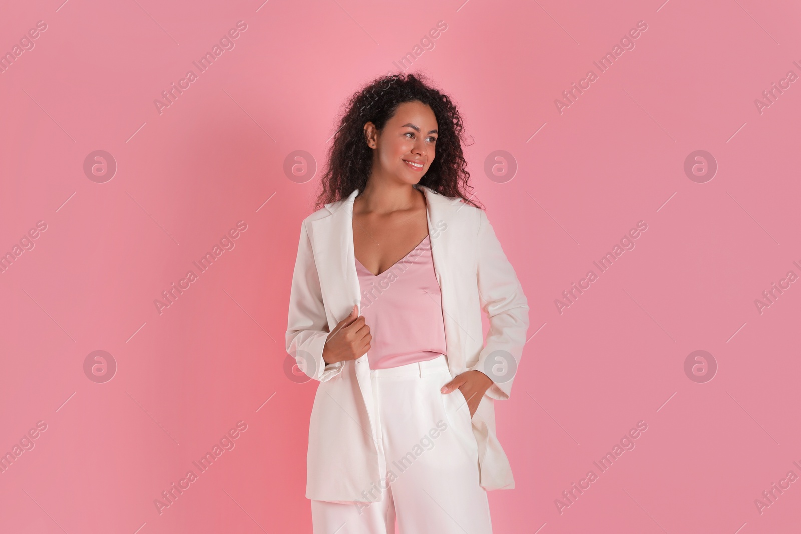 Photo of Beautiful woman in stylish suit on pink background