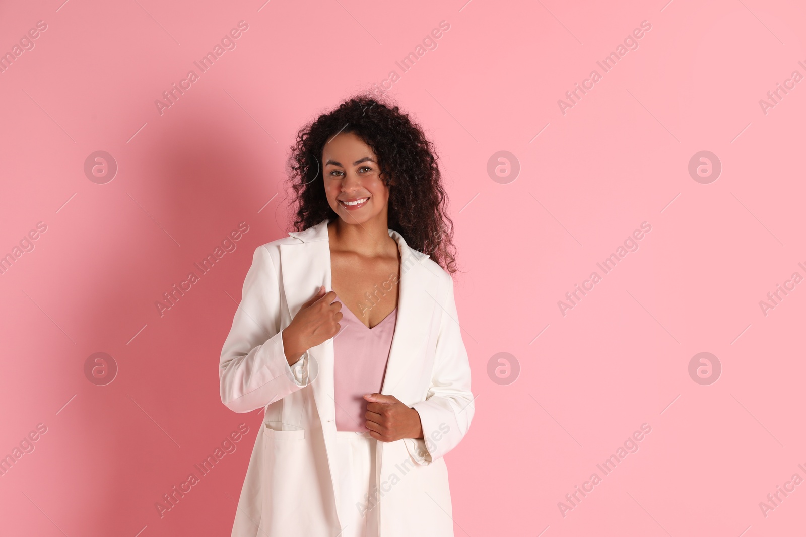 Photo of Beautiful woman in stylish jacket on pink background