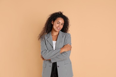 Photo of Beautiful woman in stylish jacket on beige background