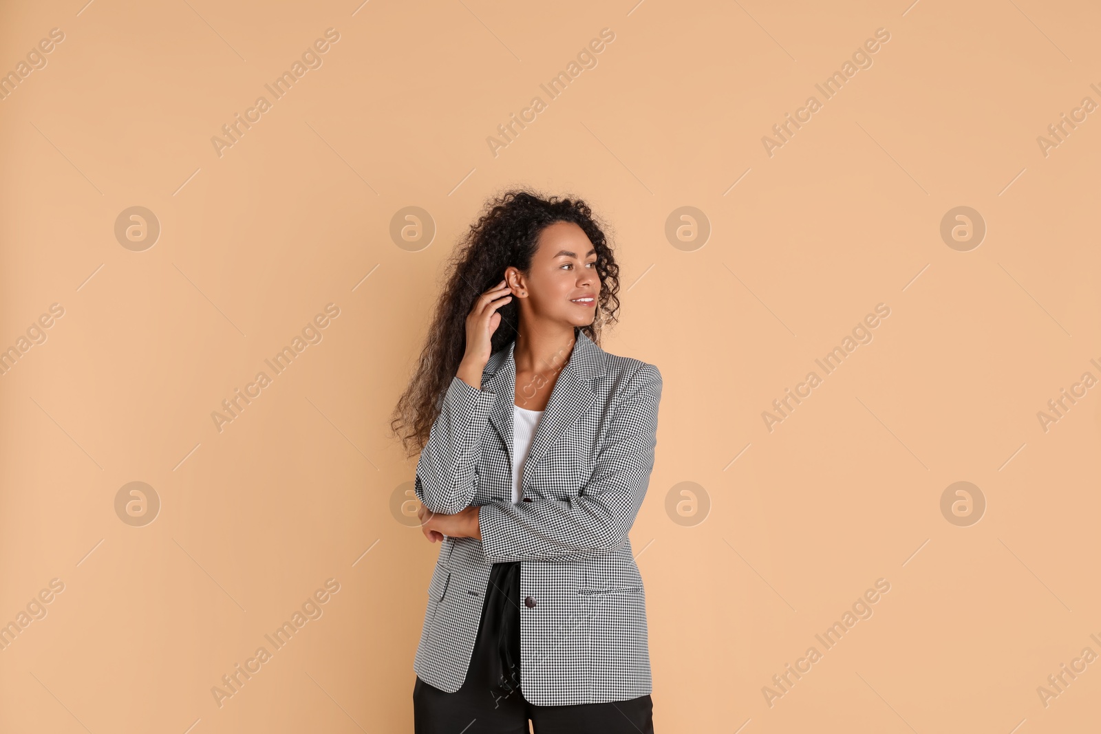 Photo of Beautiful woman in stylish jacket on beige background