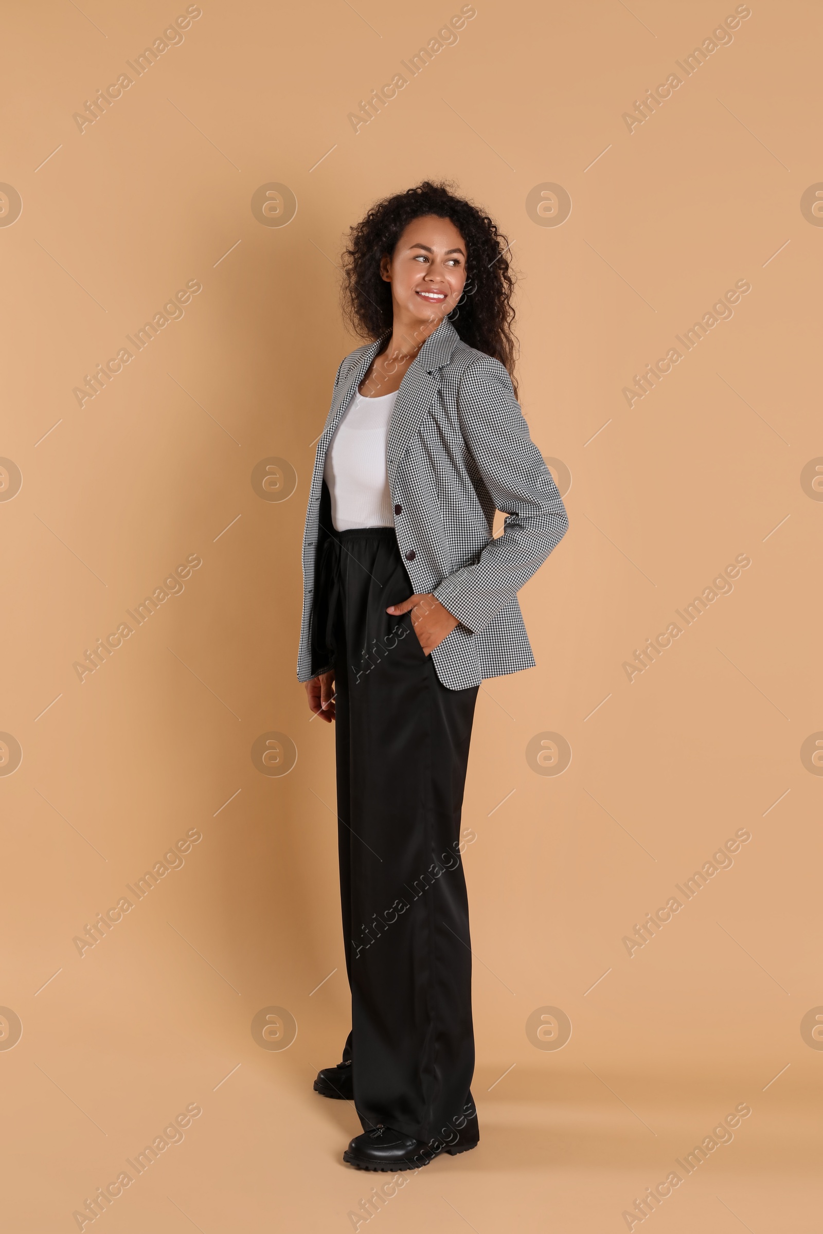 Photo of Beautiful woman in stylish jacket on beige background