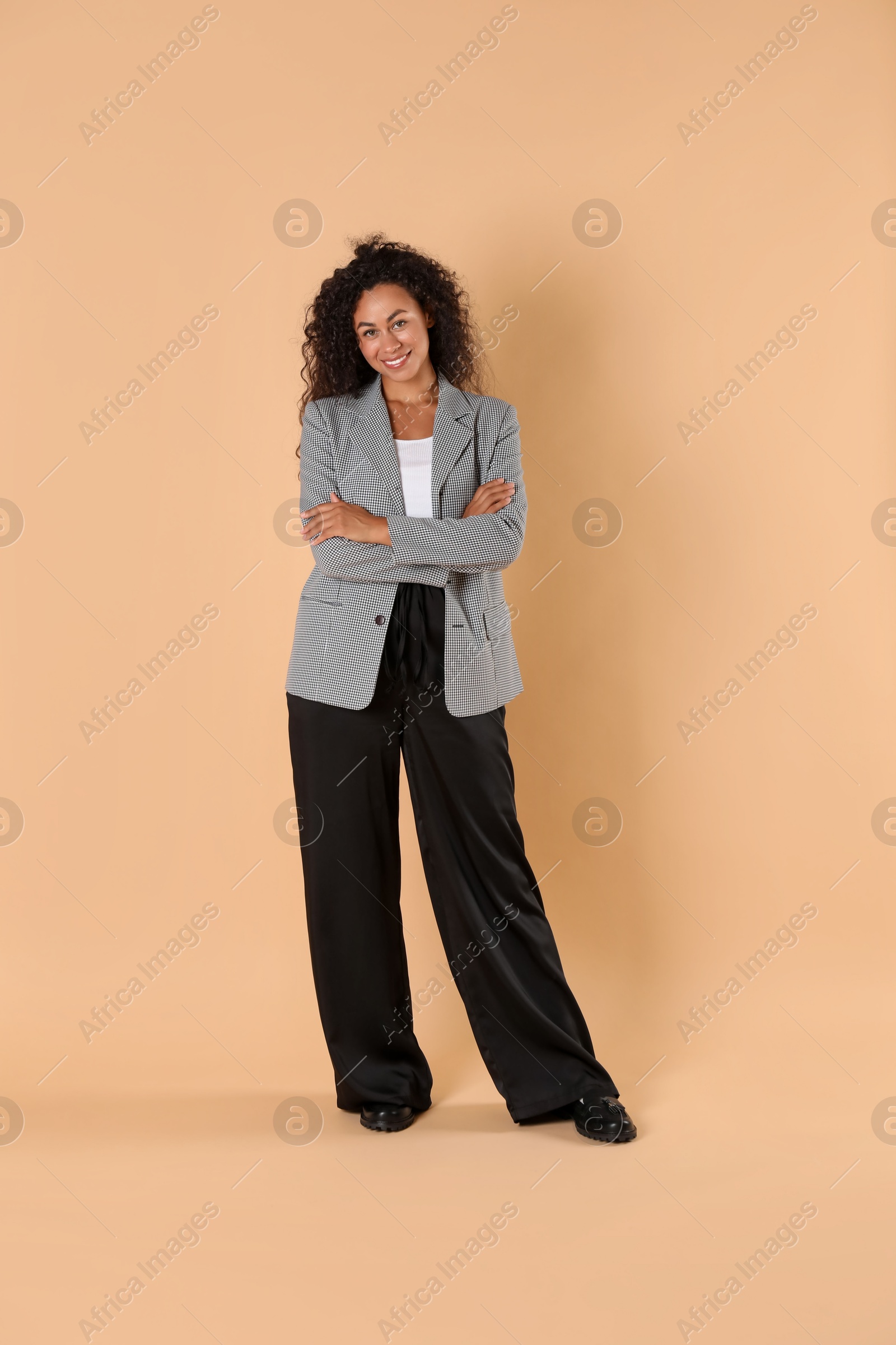 Photo of Beautiful woman in stylish jacket on beige background