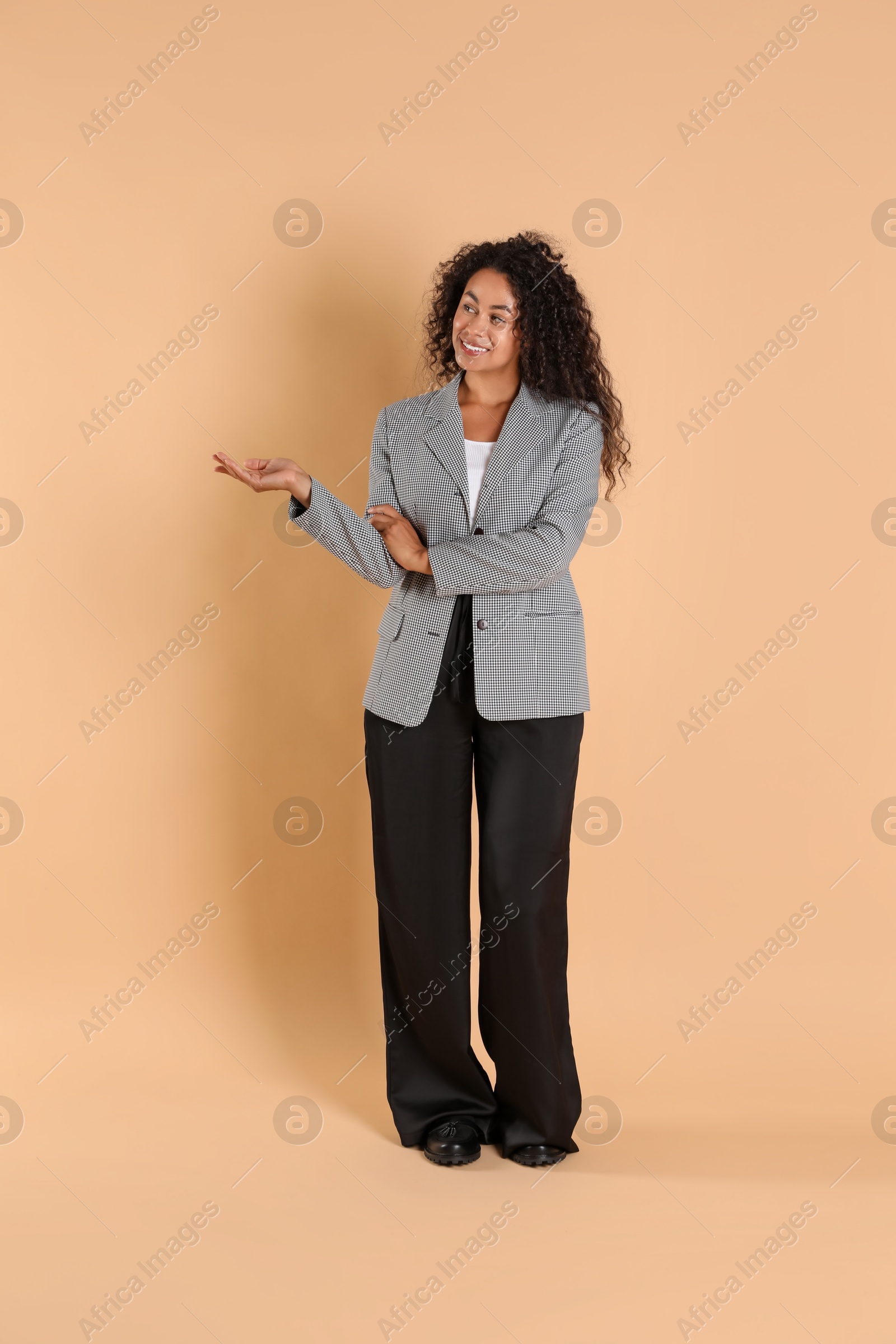 Photo of Beautiful woman in stylish jacket on beige background