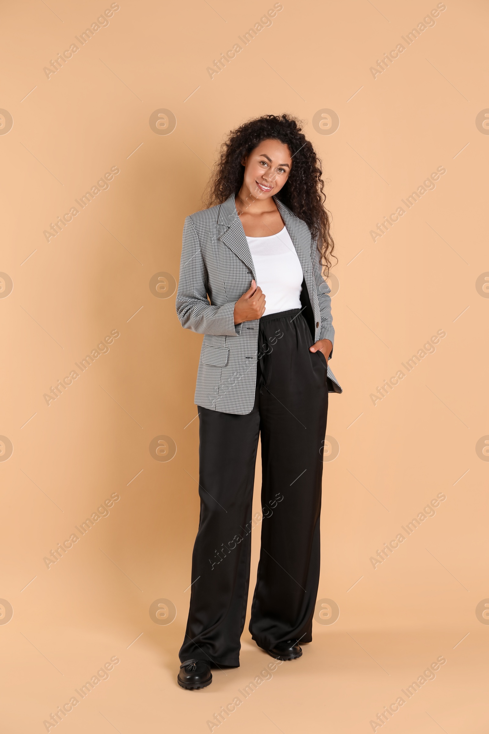 Photo of Beautiful woman in stylish jacket on beige background