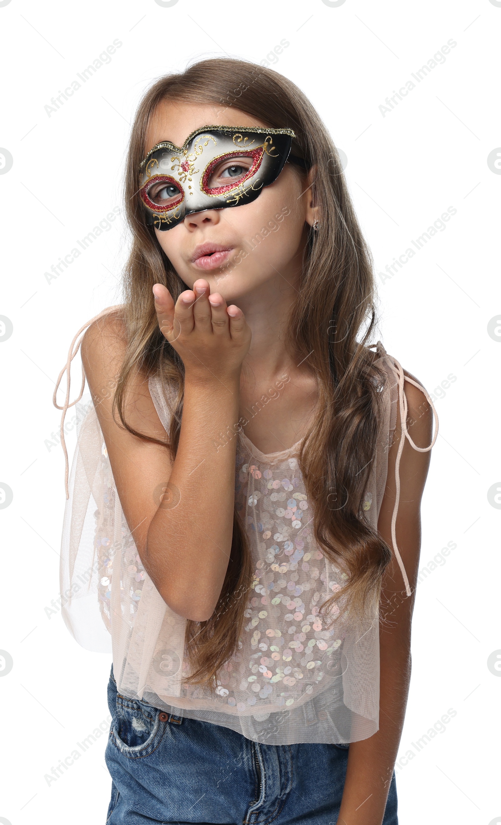 Photo of Cute girl wearing carnival mask and blowing kiss on white background