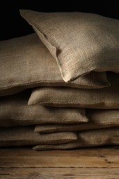 Photo of Group of burlap sacks on wooden table