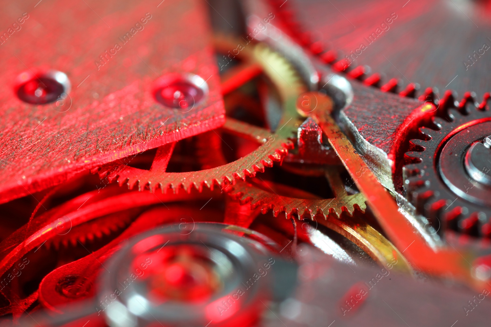 Photo of Mechanism of vintage wrist watch as background, closeup. Color toned