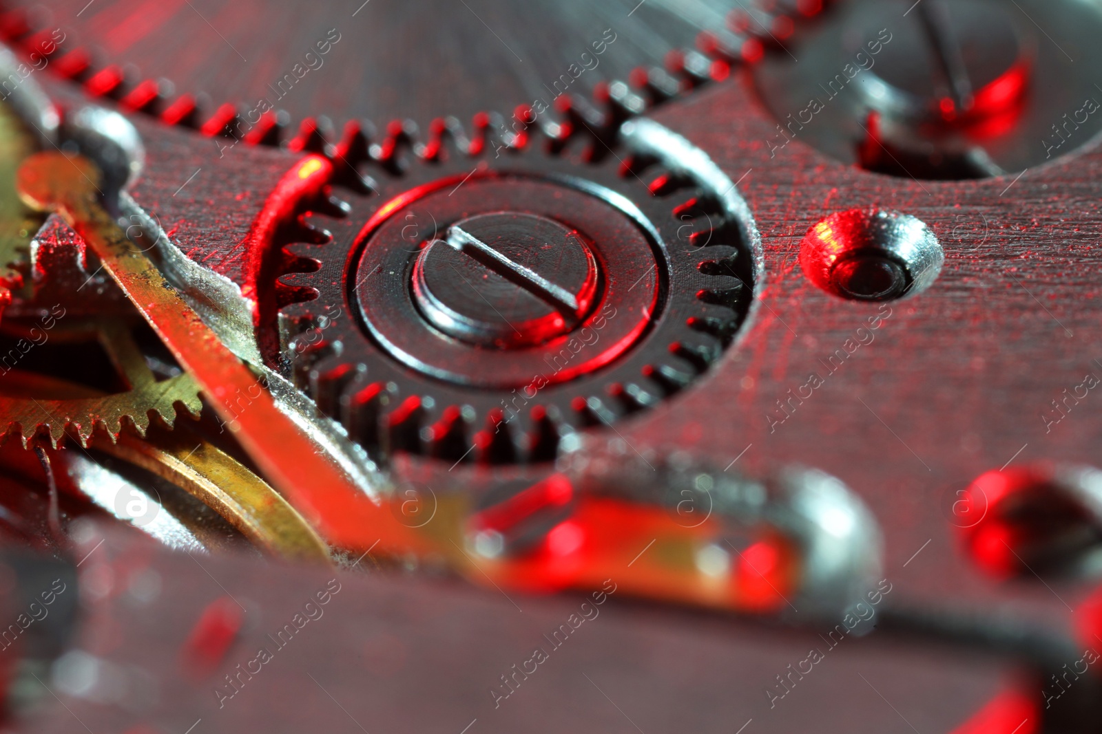 Photo of Mechanism of vintage wrist watch as background, closeup. Color toned